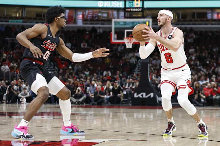Chicago Bulls guard Alex Caruso (6) shoots against Portland Trail Blazers guard Scoot Henderson (00) during the first half at United Center.
